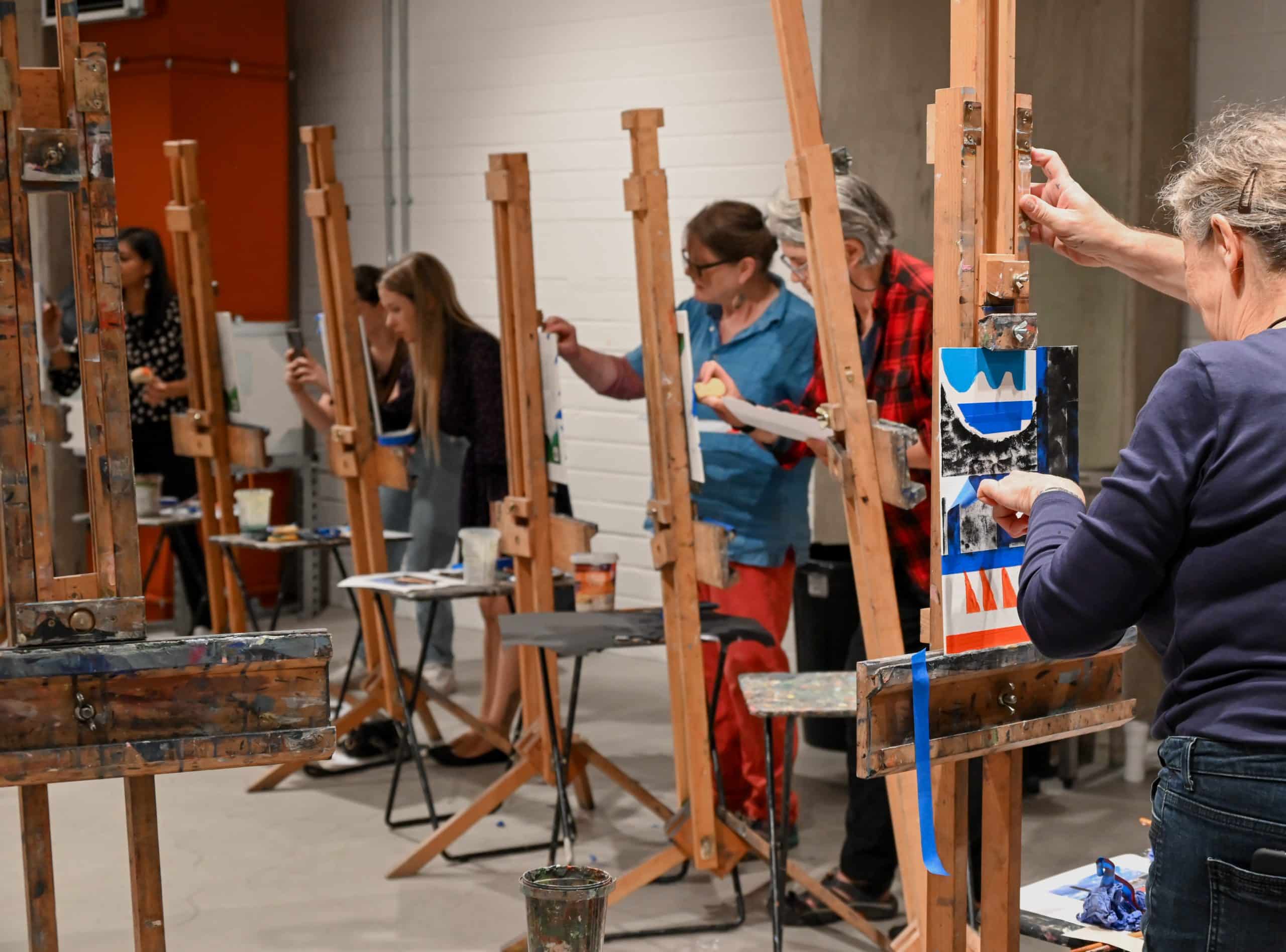 a group of people painting on easels, Christmas 2024 Gift Card